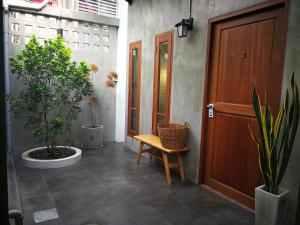 a hallway with a wooden door and some plants at baankorrakang in Bangkok Noi +48 photos