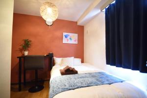 Giường trong phòng chung tại Vail sta Takenotsuka