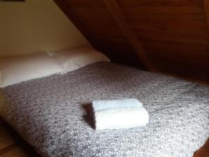 a bed with a folded towel on top of it at The Innlet, Country Apartments and Cottages in Collingwood