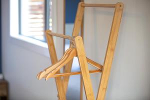 a wooden chair sitting in front of a window at 34 Mackenzie Apartments in Twizel