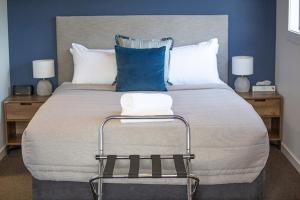 a bedroom with a large bed with blue walls at 34 Mackenzie Apartments in Twizel