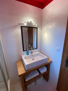 a bathroom with a sink and a mirror at Ferienwohnung Sunneschii in Davos +12 photos