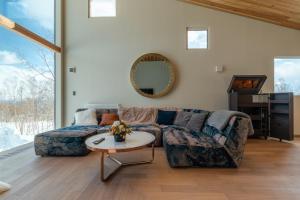 a living room with a couch and a table at Foxwood D in Niseko