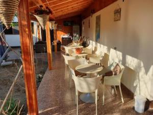 a row of tables and chairs in a restaurant at Casa Carter in Sfântu Gheorghe