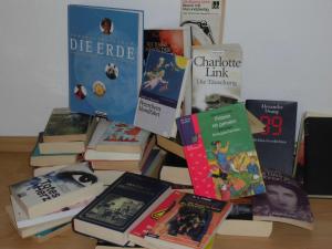 a pile of books sitting on top of a table at Centrum, Centrum, direkt im Centrum! in Leipzig