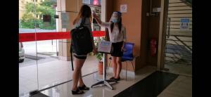 two women standing in front of a store at Parc Hotel Pelangi Damansara in Kota Damansara