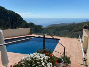a swimming pool with a view of the mountains at La Roqueta Hotel in Tossa de Mar