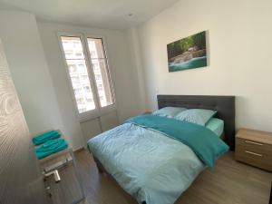 a bedroom with a bed and a window at 219 Promenade in Nice