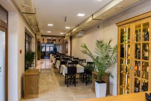 a restaurant with tables and chairs in a room at Melania in Uman