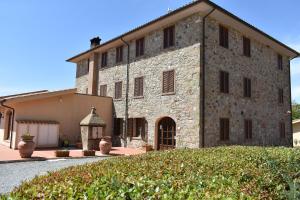 a large stone building with a garden in front of it at Borgo di Pomaia in Pomaia