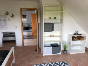 Cette chambre dispose d'étagères blanches et d'un escalier. dans l'établissement Ferienwohnung mit Blick auf die Burg Stargard, à Burg Stargard