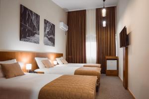 Postel nebo postele na pokoji v ubytování Sajam Garni hotel