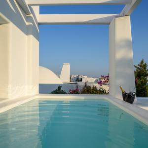 a swimming pool in a villa with a view at Antoperla Luxury Hotel & Spa in Perissa