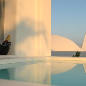a bottle of champagne sitting on a shelf with a window at Antoperla Luxury Hotel & Spa in Perissa
