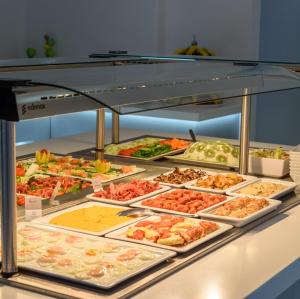 a buffet line with many different types of food at Antoperla Luxury Hotel & Spa in Perissa