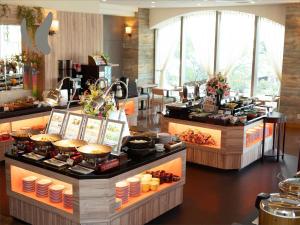 a buffet line with food on display in a restaurant at Almont Hotel Naha Omoromachi in Naha