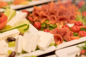 a plate of food with meats and vegetables on at Antoperla Luxury Hotel & Spa in Perissa