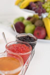 a table with two bowls of fruit on a table at Antoperla Luxury Hotel & Spa in Perissa