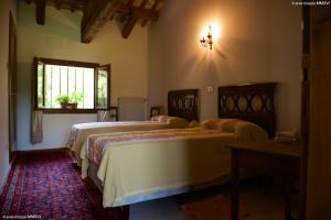 En eller flere senge i et værelse på Villa Mainardi Agriturismo