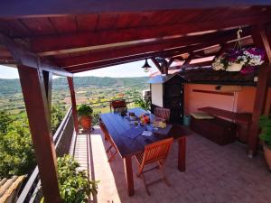 a patio with a table and chairs on a balcony at La Fenice in Montefiascone