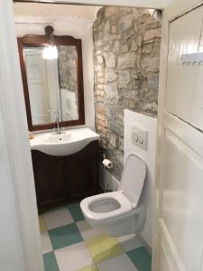a bathroom with a white toilet and a sink at Bed & Breakfast Dèco in Torno