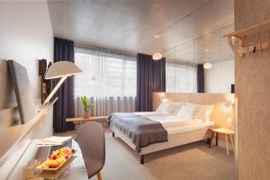 a hotel room with a bed and a table at Zander K Hotel in Bergen