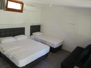 a bedroom with two beds and a couch at My Bungalov in Mesudiye +45 photos