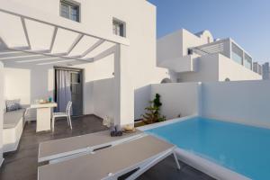 a villa with a swimming pool and a house at Antoperla Luxury Hotel & Spa in Perissa