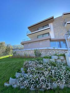 a building with a pile of flowers in front of it at My Lake Apartments in Malcesine