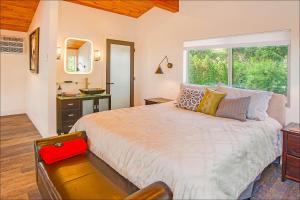 a bedroom with a large bed and a window at Lake Level Cottages in Oroville