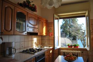 a kitchen with a sink and a stove and a window at Villa Margherita - Rebomaholidays in Tignale