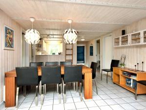a dining room with a table and chairs at 12 person holiday home in Nordborg in Nordborg