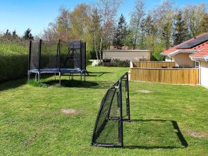 a playground in a yard with a swing set at 12 person holiday home in Nordborg in Nordborg