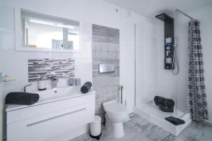 a bathroom with a sink and a toilet and a shower at Boutique-Hotel UPGRADE in Wernigerode