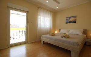 a bedroom with a bed with two teddy bears on it at Apartments Klaric in Pirovac