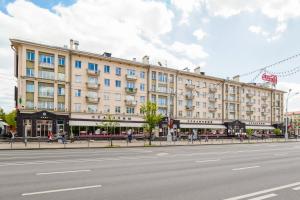 a large building on the side of a street at Apartments on Ploscha Yakuba Kolasa in Minsk
