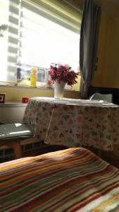 a table with a vase of flowers on top of it at Haus Tertius - Strand- und hafennahe ruhige Ferienwohnung in Büsum