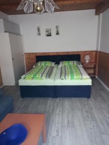 Schlafzimmer mit einem Bett und einem Tisch in der Unterkunft Ubytování Maxa in Špičák