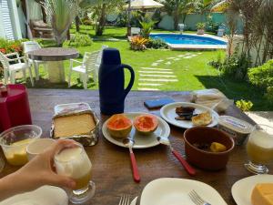 a table with breakfast foods and drinks on it at Casa Estância do Mar in Olivença