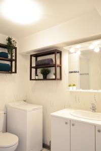 Baño blanco con aseo y lavamanos en Le Flav - Charmant appartement à 10 mn de Dijon, en Flavignerot