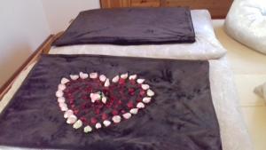 a cake in the shape of a heart on a bed at Chalet zur Schmiede in Liebenfels