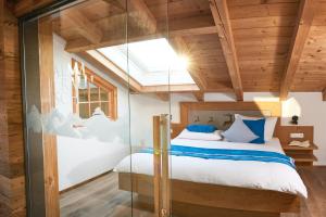 a bedroom with a bed and a glass wall at Alpvilla Bietsch in Oberstdorf