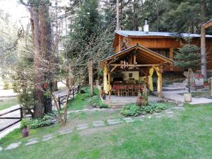 a log cabin with a porch in the woods at Moon Valley in Popovi Livadi