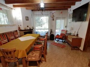 a dining room with a table and some chairs at Moon Valley in Popovi Livadi