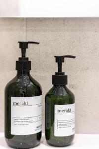 two bottles of vinegar sitting next to each other at Casa Boma Lisboa - Design and Sunny Apartment - Lapa I in Lisbon