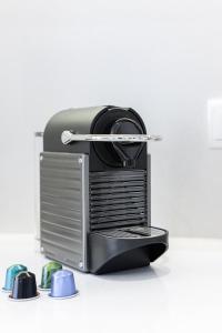 a toaster sitting on top of a white table at Casa Boma Lisboa - Design and Sunny Apartment - Lapa I in Lisbon