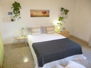 1 dormitorio con 1 cama grande y 1 mesa en EcoBoutique house, self check-in - free car parking, en Cagliari