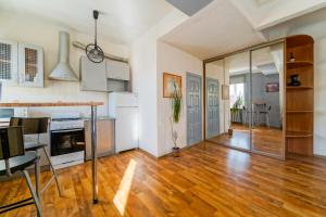 an open kitchen and living room with a hard wood floor at In the center of Minsk in Minsk