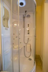 a bathroom with a shower stall and a toilet at A Park View Hotel in Wolverhampton