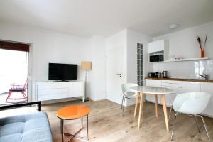 a living room with a couch and a table at Arthouse Apartments im Pantaleonsviertel in Cologne